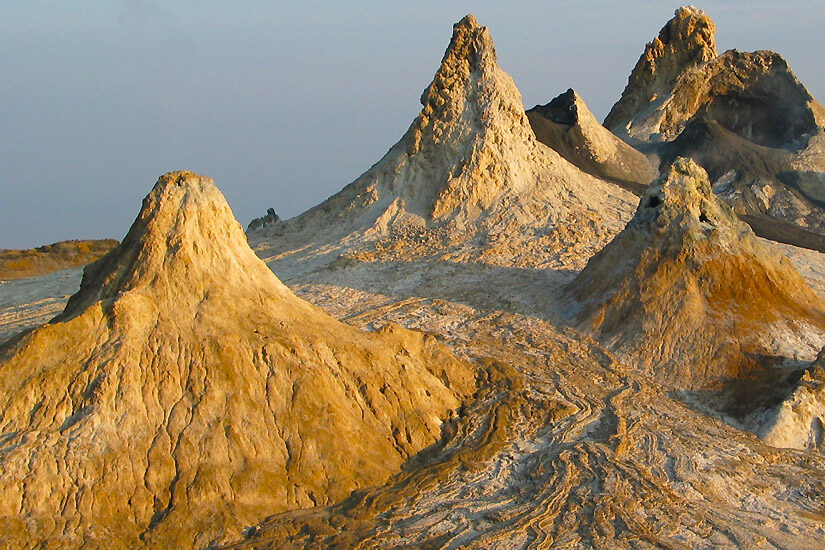 The unique volcanic landscape and small craters of Ol Doinyo Lengai mountain, featured in the Pure Afro Travels trekking gallery.